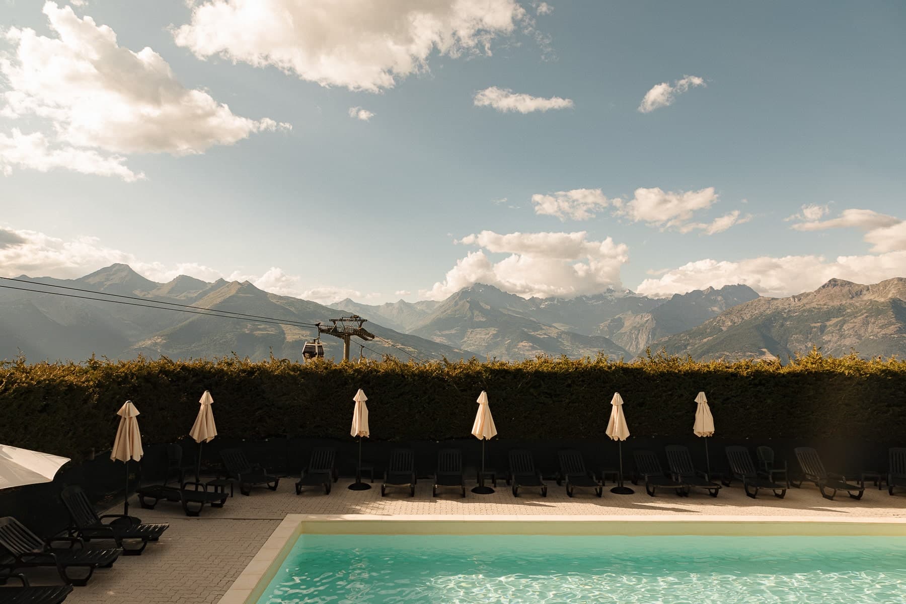 The Yeti panoramic pool with umbrellas and mountain views